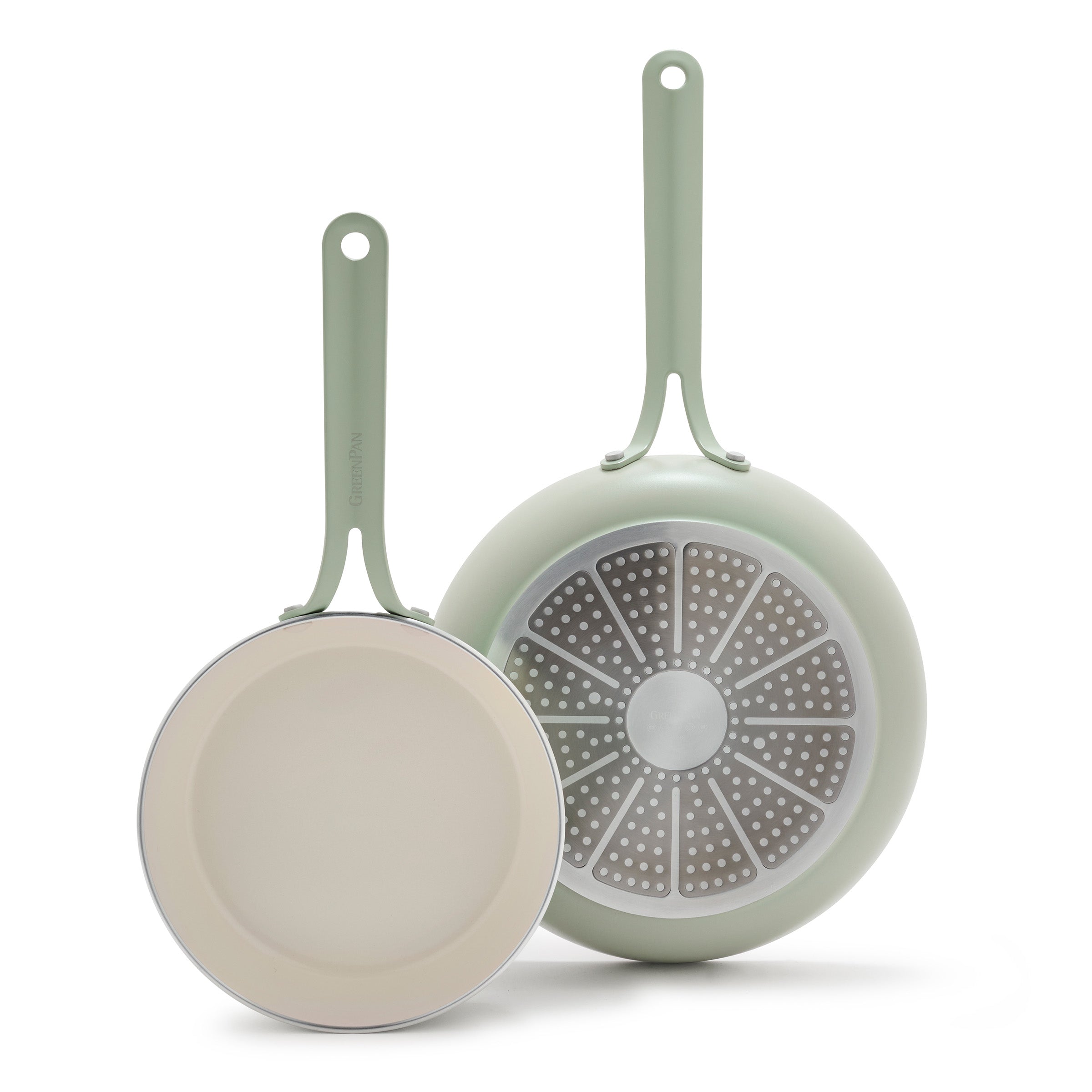 Two green frying pans on a white background