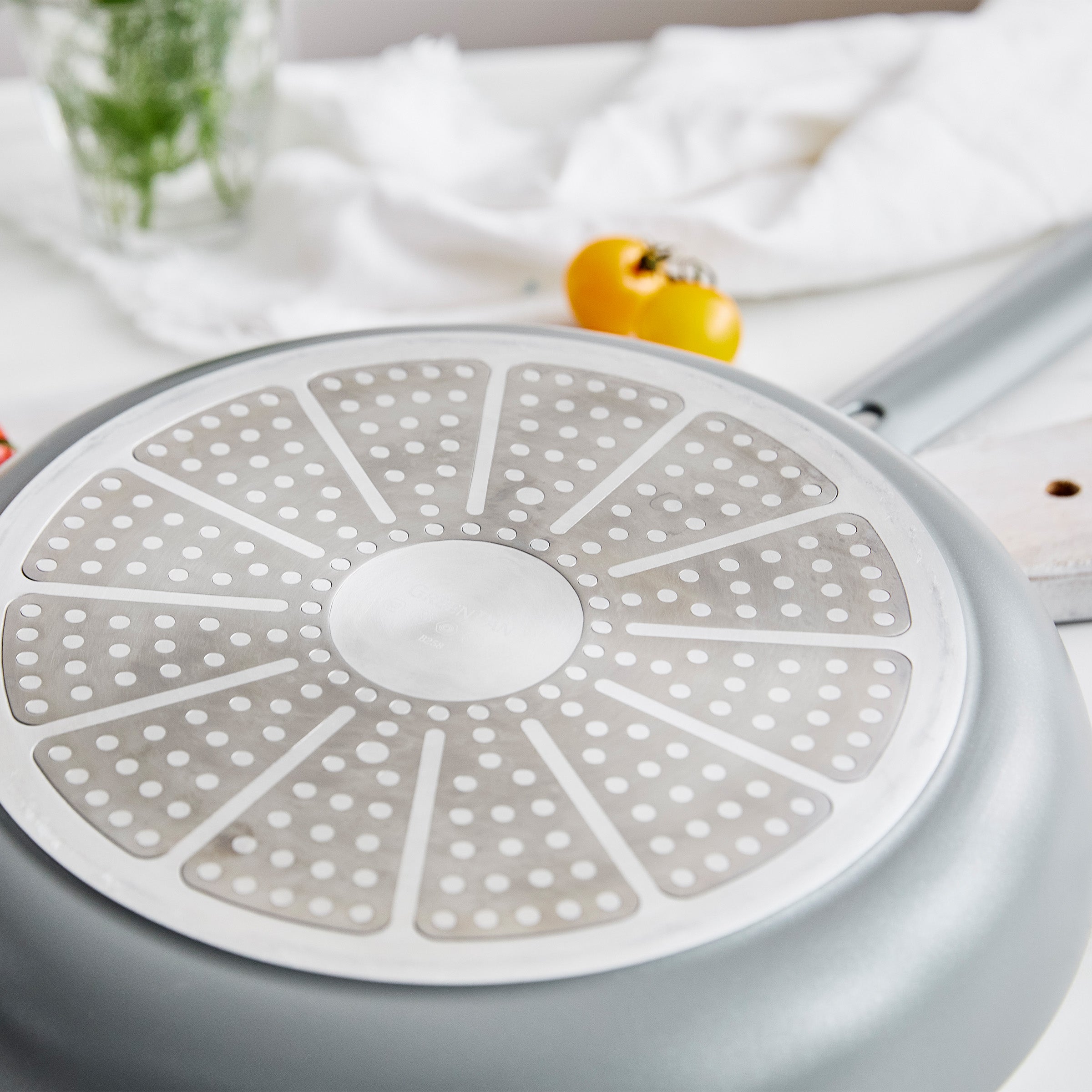 Gray frypan on a white surface