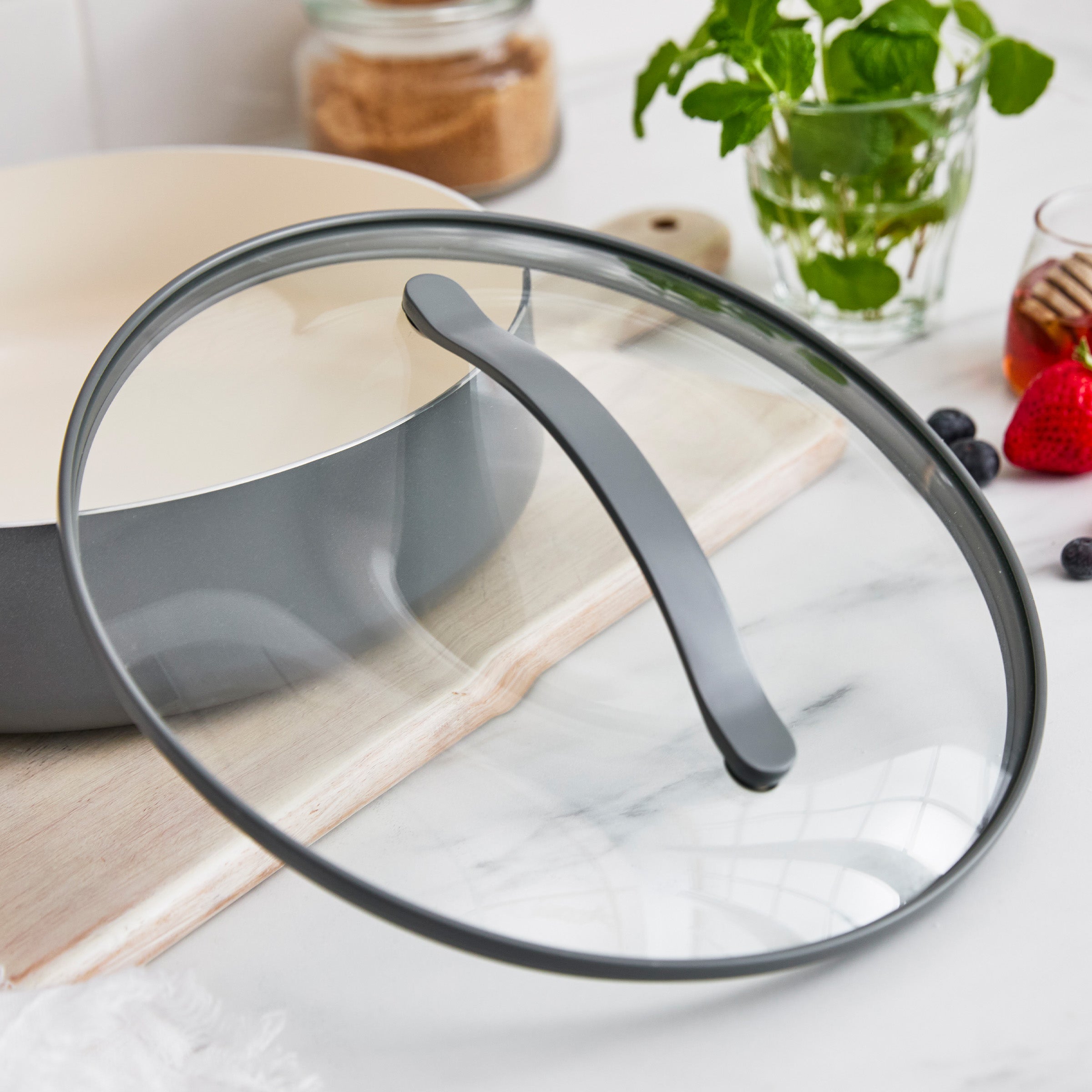Glass lid on a pot with a kitchen setting in the background