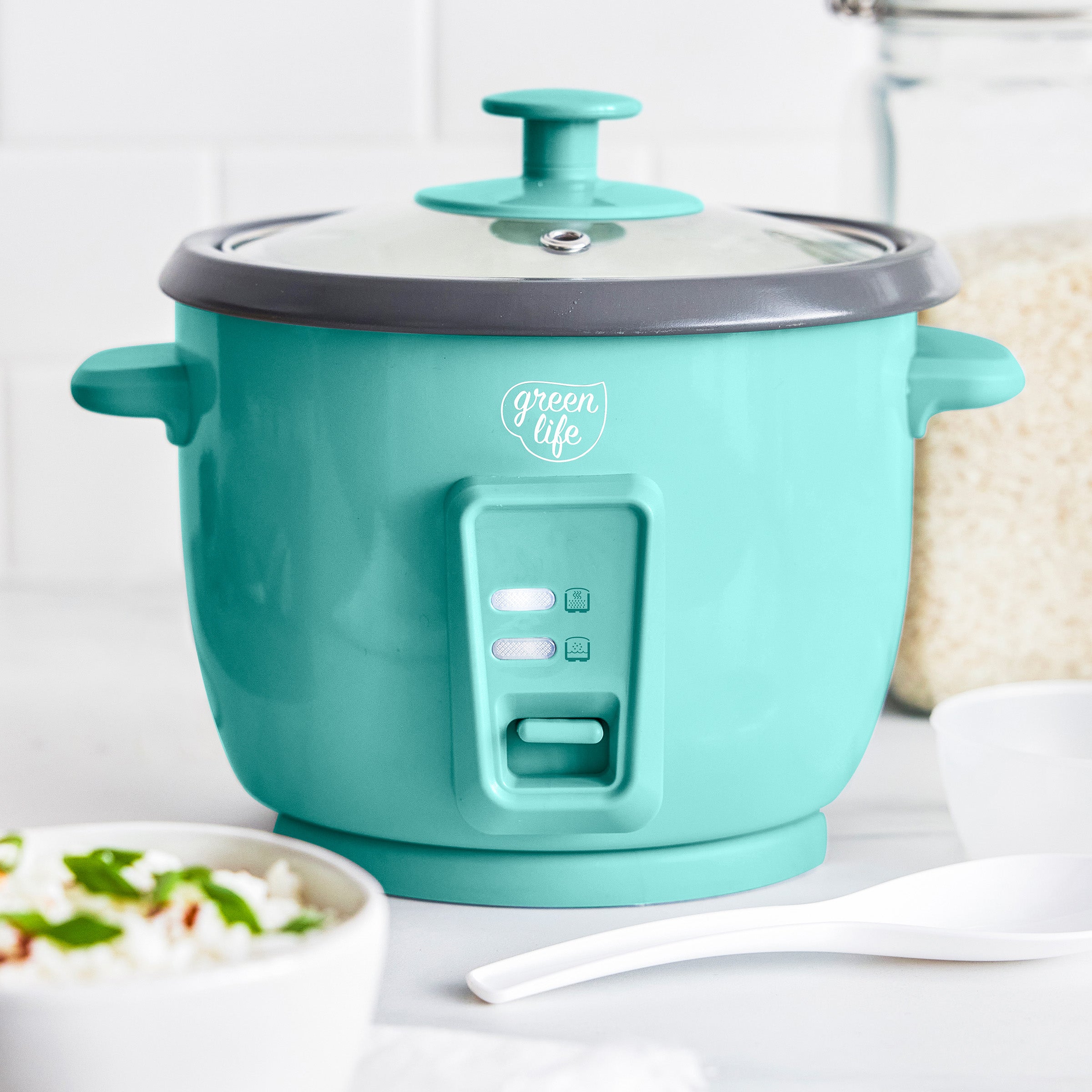 Turquoise rice cooker with 'green life' branding on a white surface.