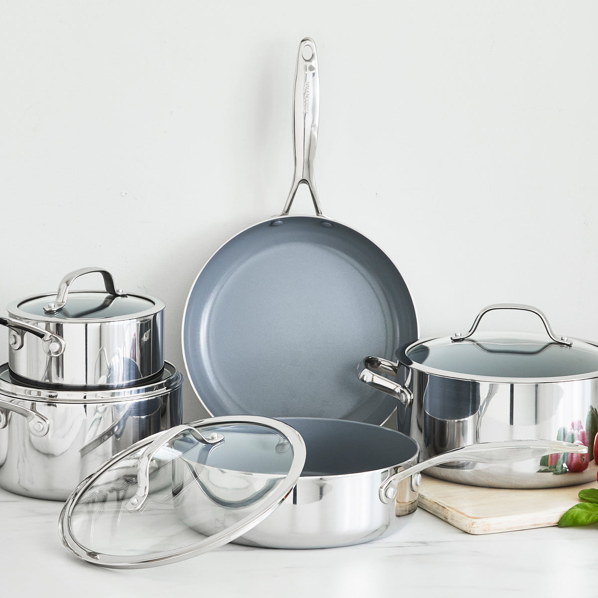 Valencia Pro 9-piece stainless steel cookware set including pots, a frying pan, and glass lids.