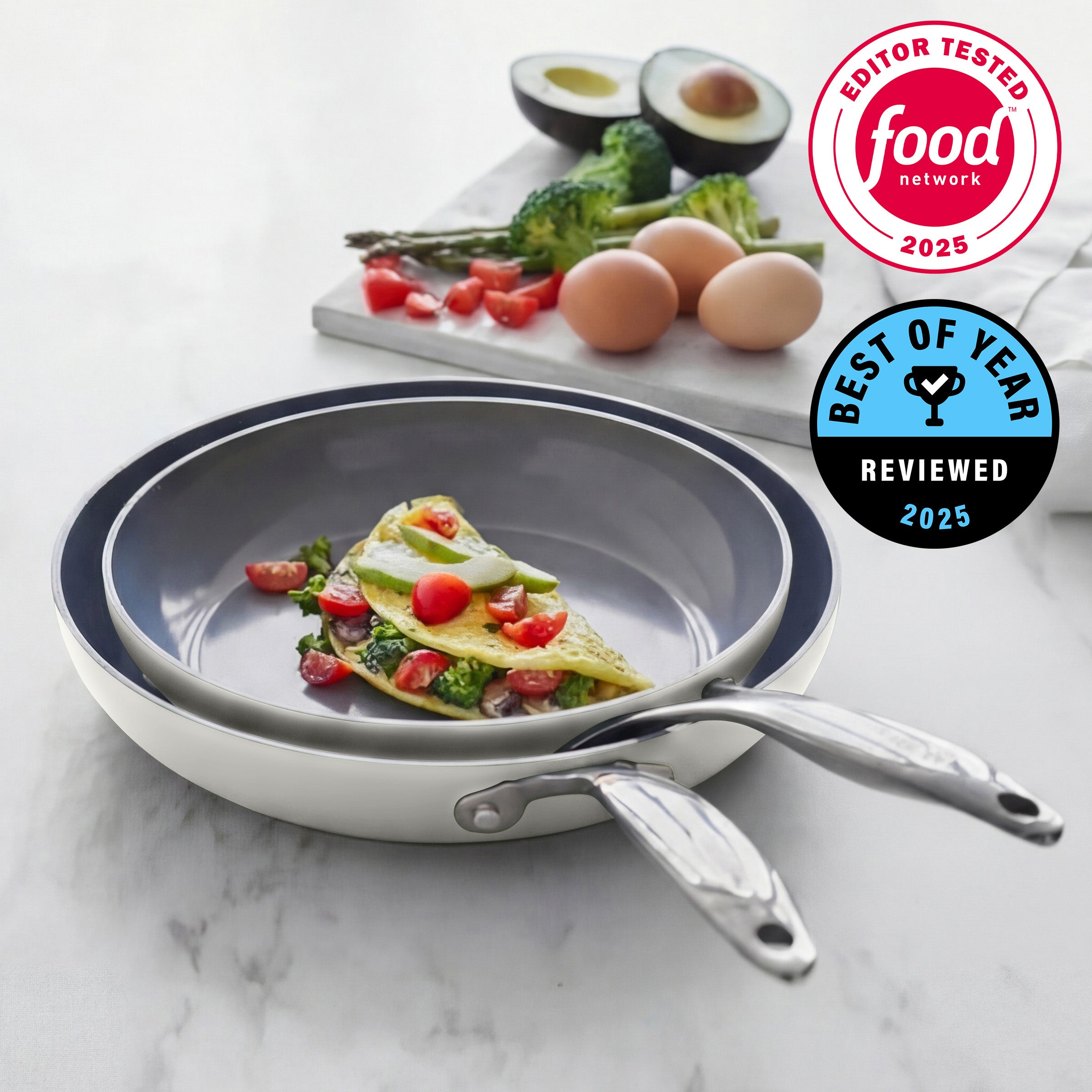 Stack of frying pans on a marble surface with food and ingredients in the background, featuring Food Network logos.