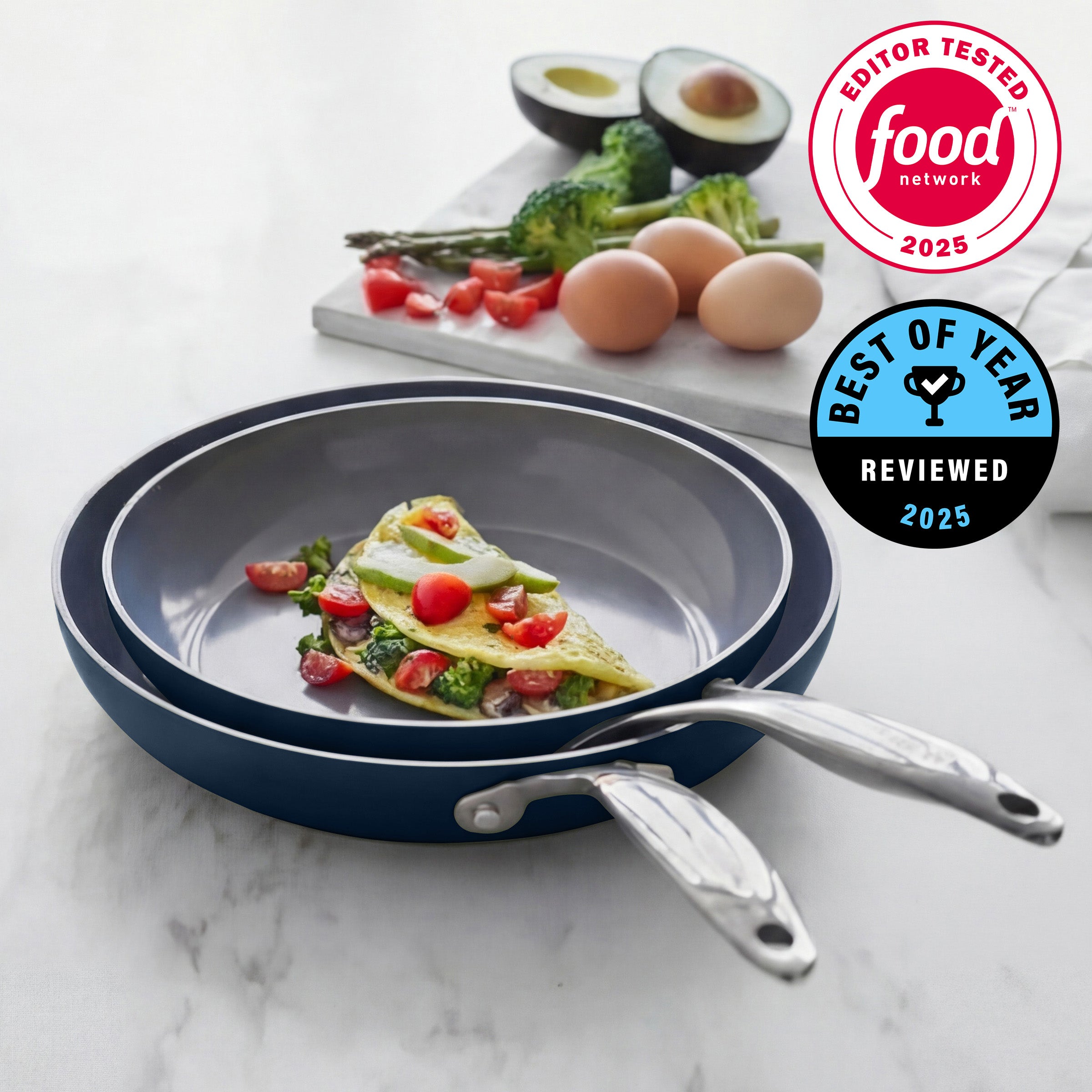 Stack of frying pans on a marble surface with food and ingredients in the background, featuring Food Network logos.