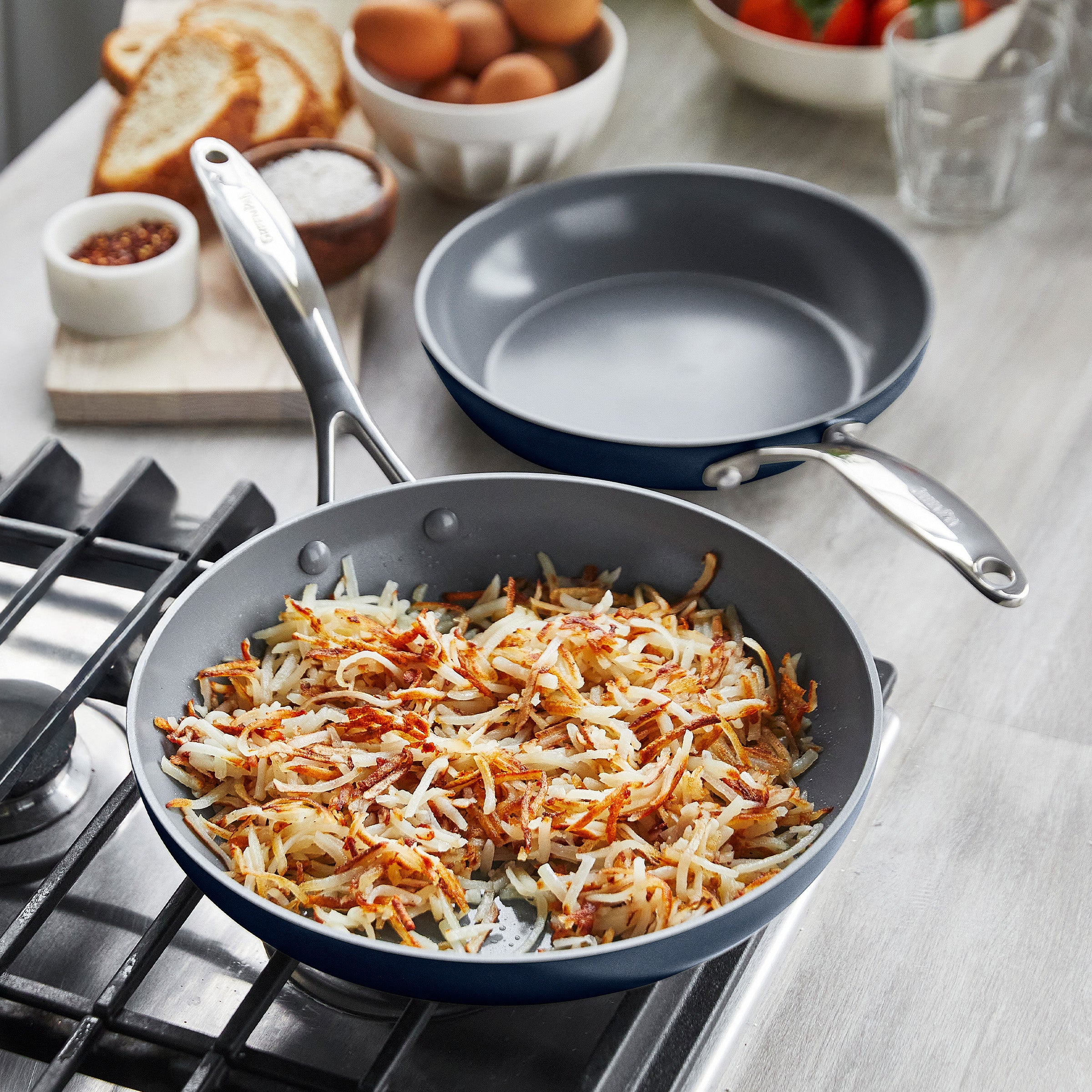 Cooking hashbrowns in a frypan on a gas stove