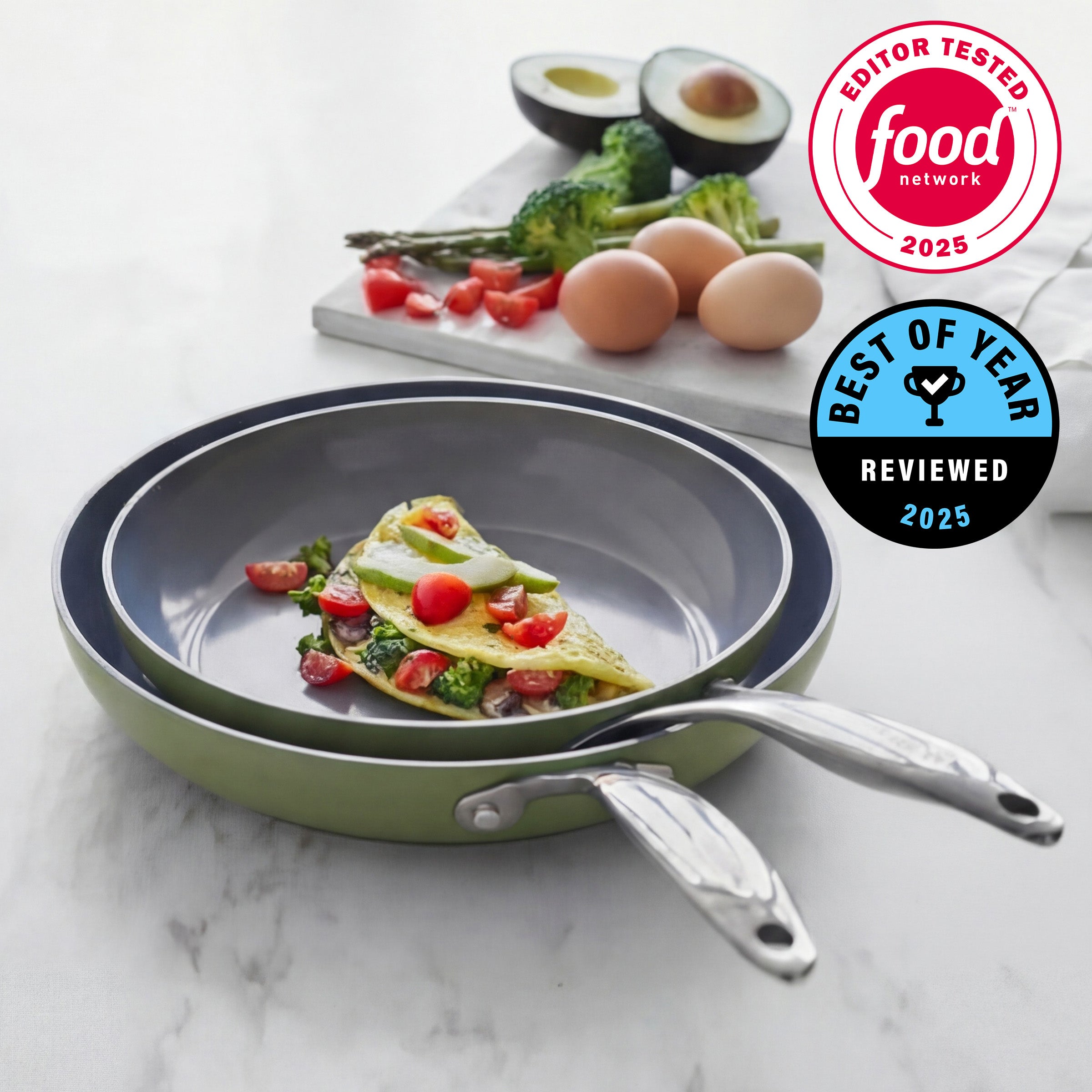 Stack of frying pans on a marble surface with food and ingredients in the background, featuring Food Network logos.