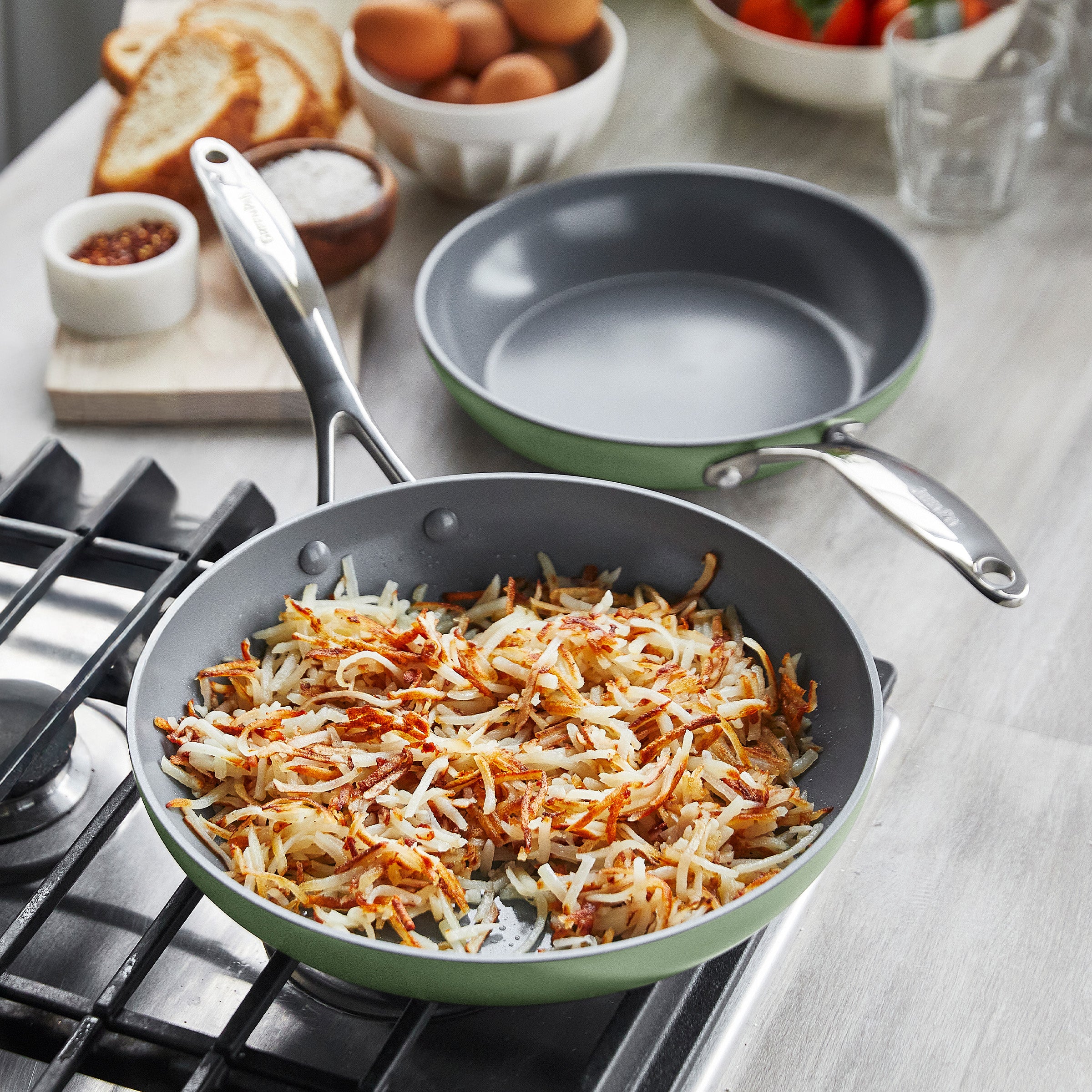 Cooking hashbrowns in a frypan on a gas stove
