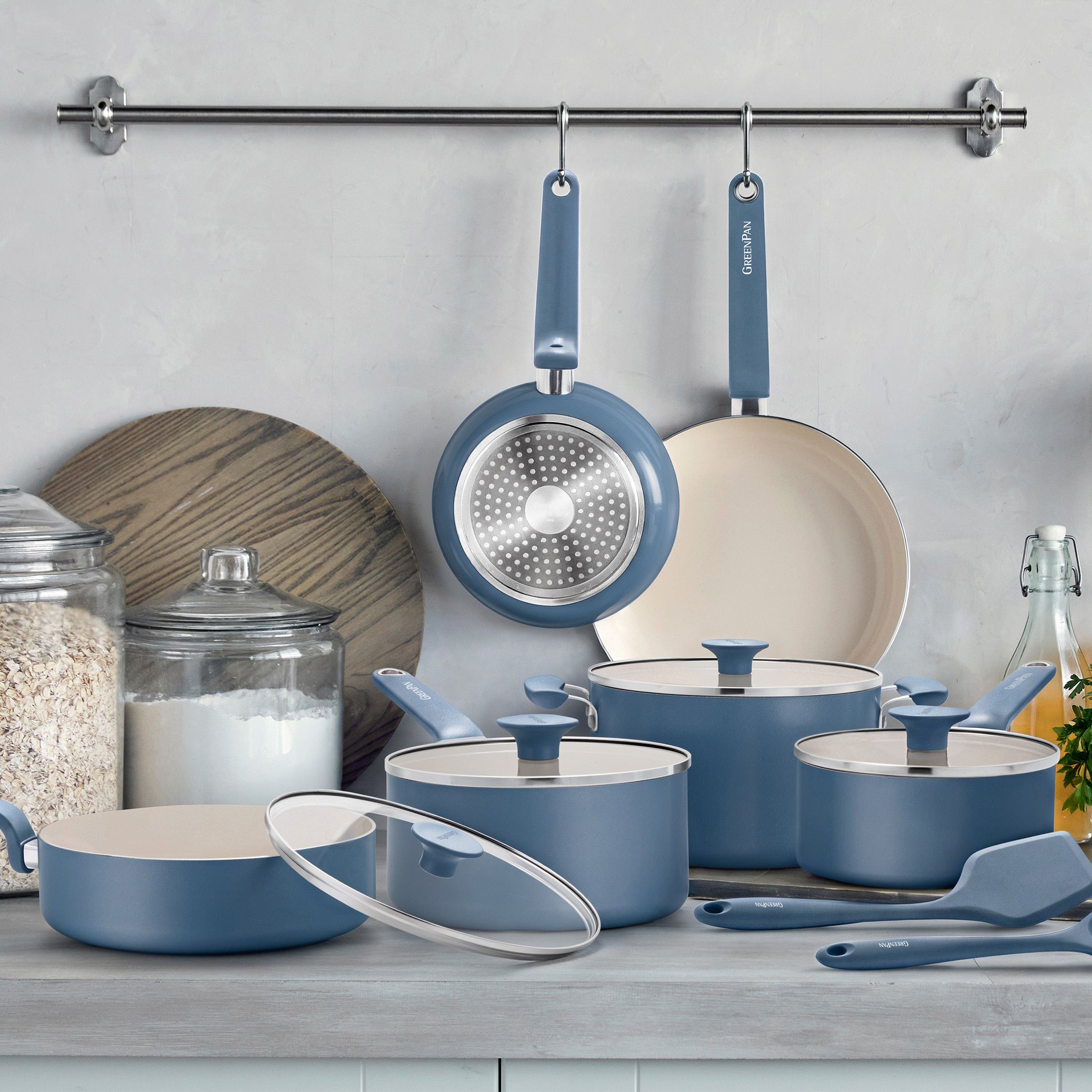 12-piece Dutch blue ceramic cookware set with pots, pans, and lids arranged on a kitchen counter.