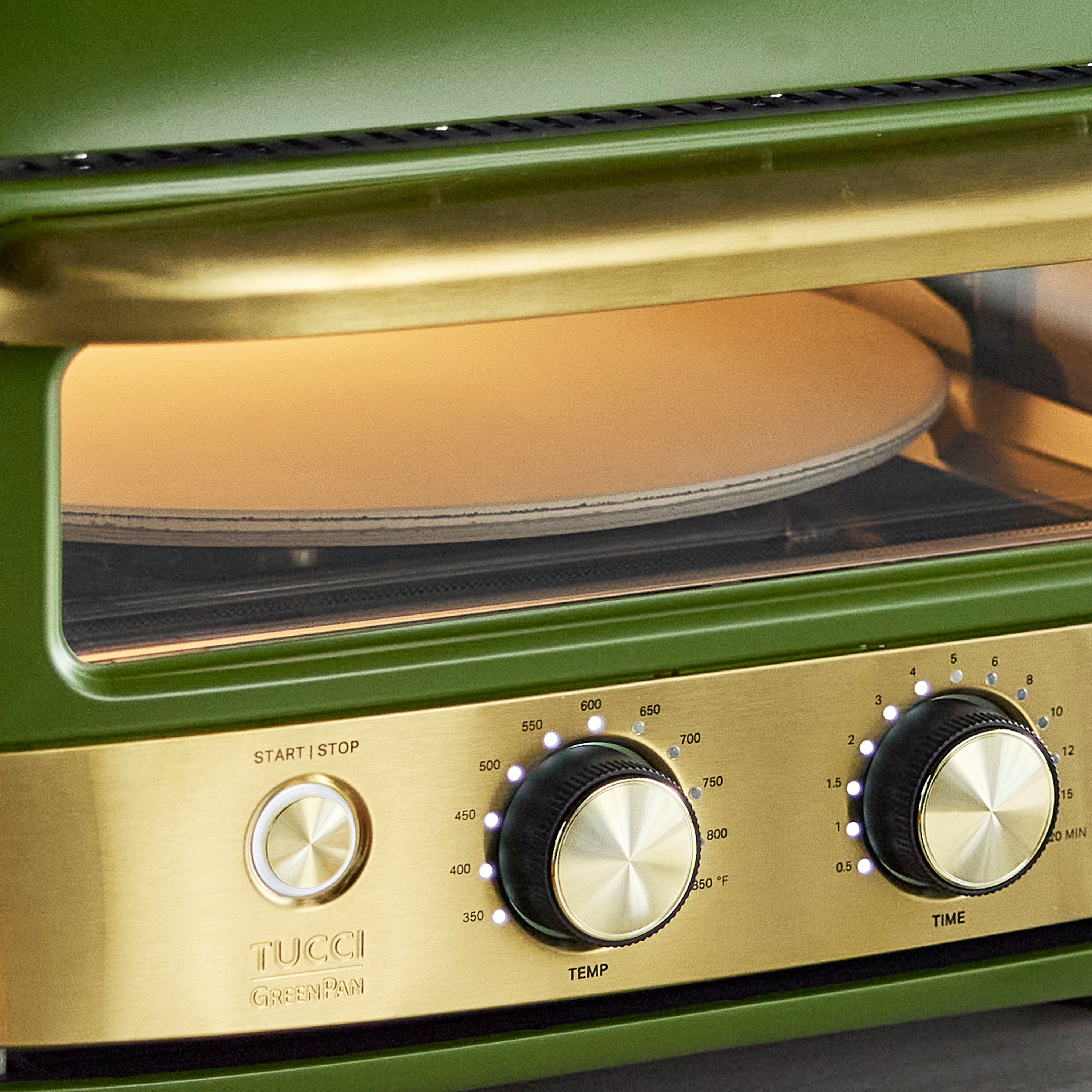 Green pizza oven with a pizza stone inside