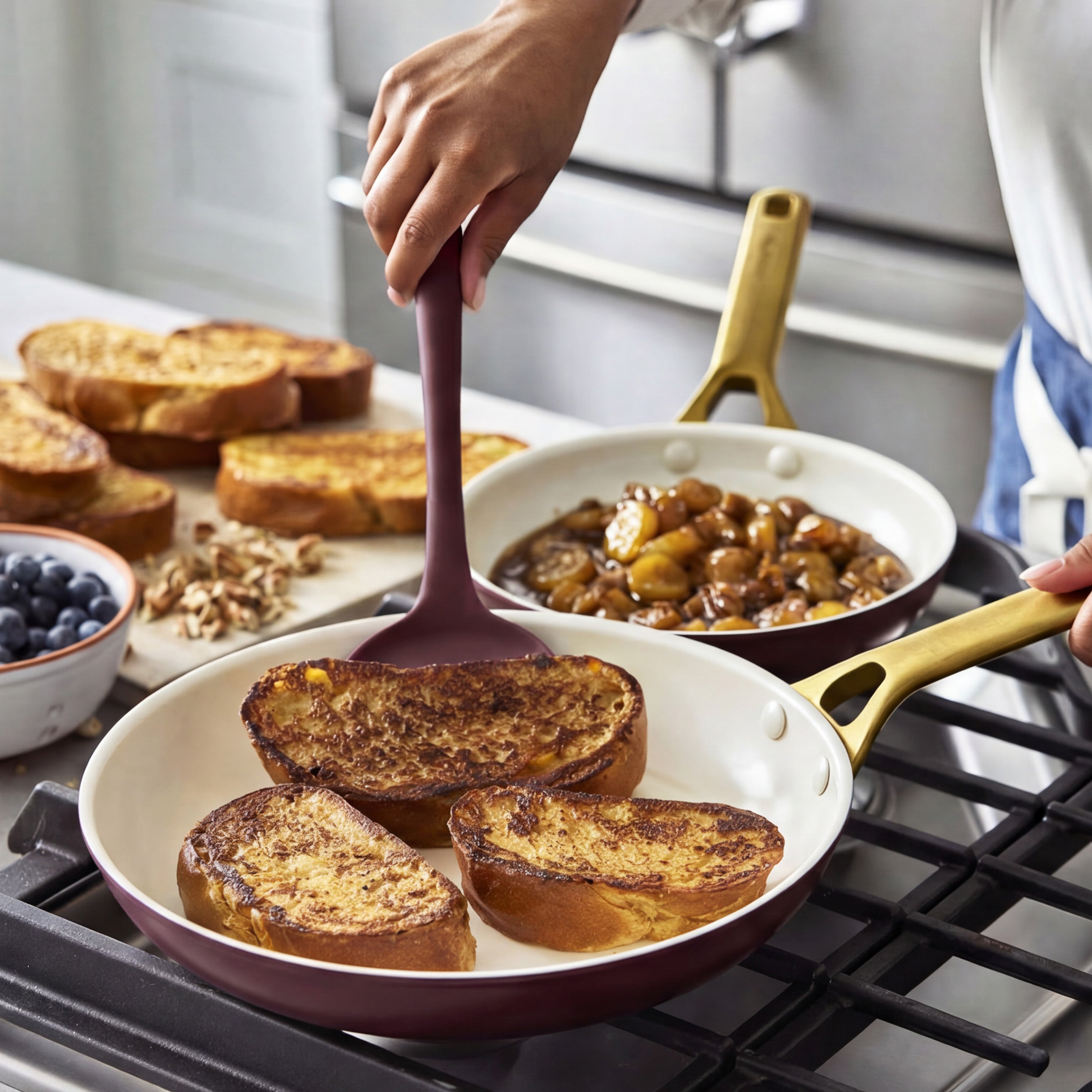 French toast cooking in Bordeaux ceramic nonstick frypan set, served with caramelized bananas, blueberries, and nuts on the side.
