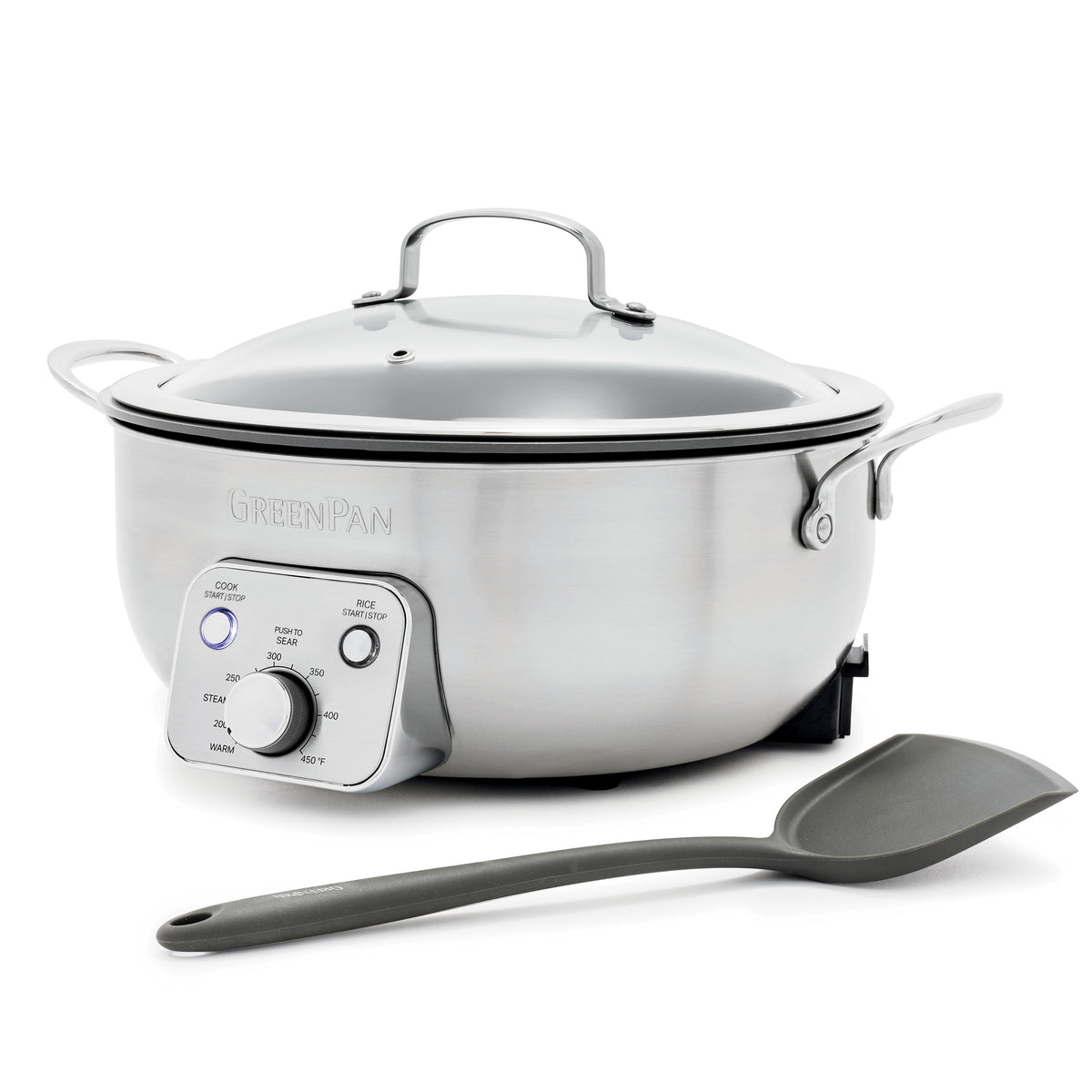 Electric wok with glass lid and control panel next to a gray spatula on a white background.