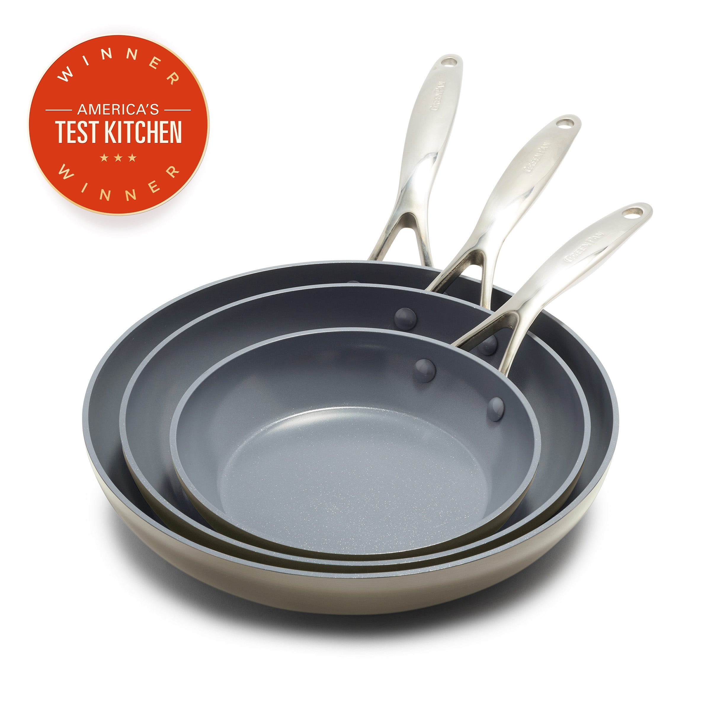 Set of three taupe frying pans with metallic handles stacked, Americas Test Kitchen Winner badge in top left corner.