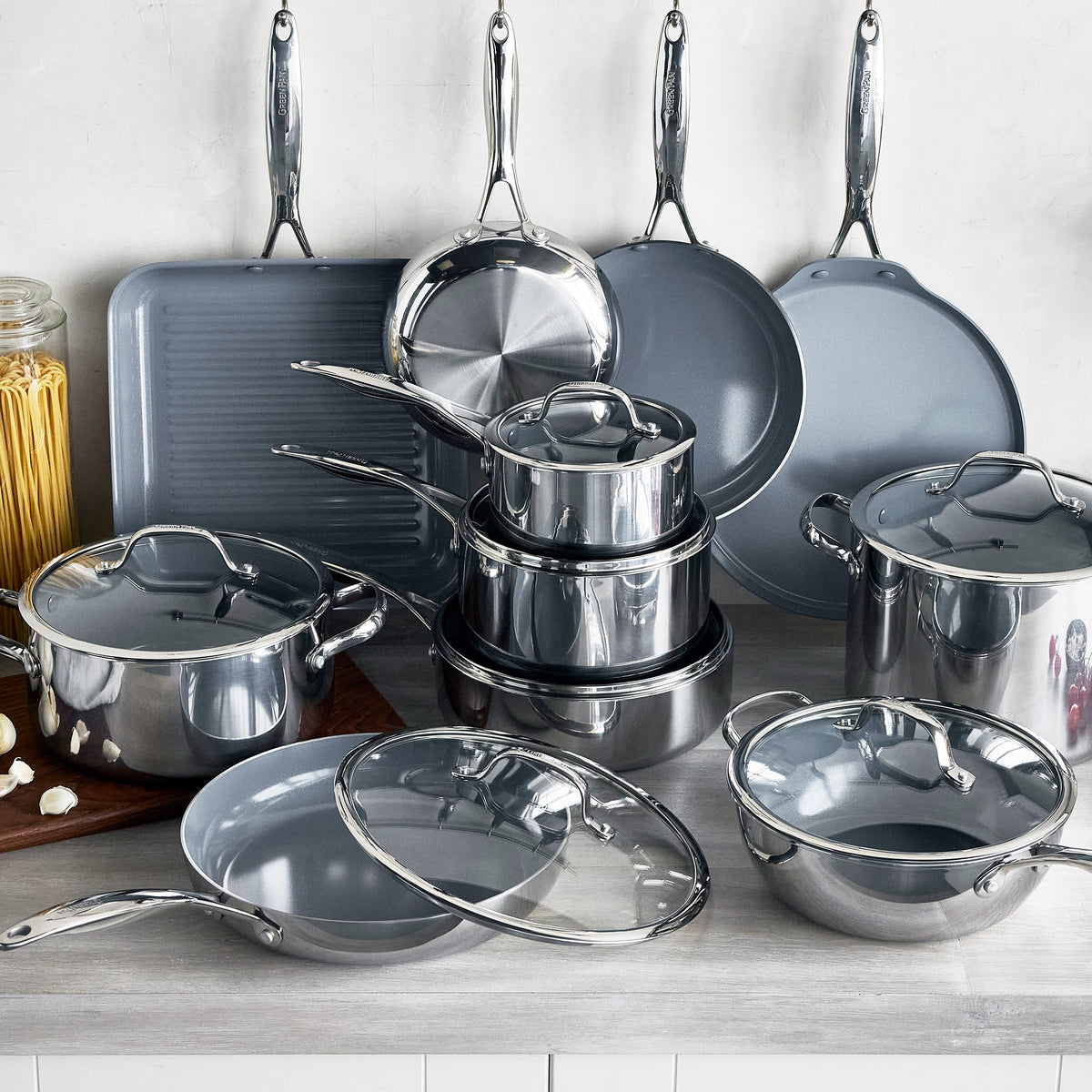 Valencia Pro 18-piece stainless steel cookware set with ceramic nonstick surfaces and matching glass lids.