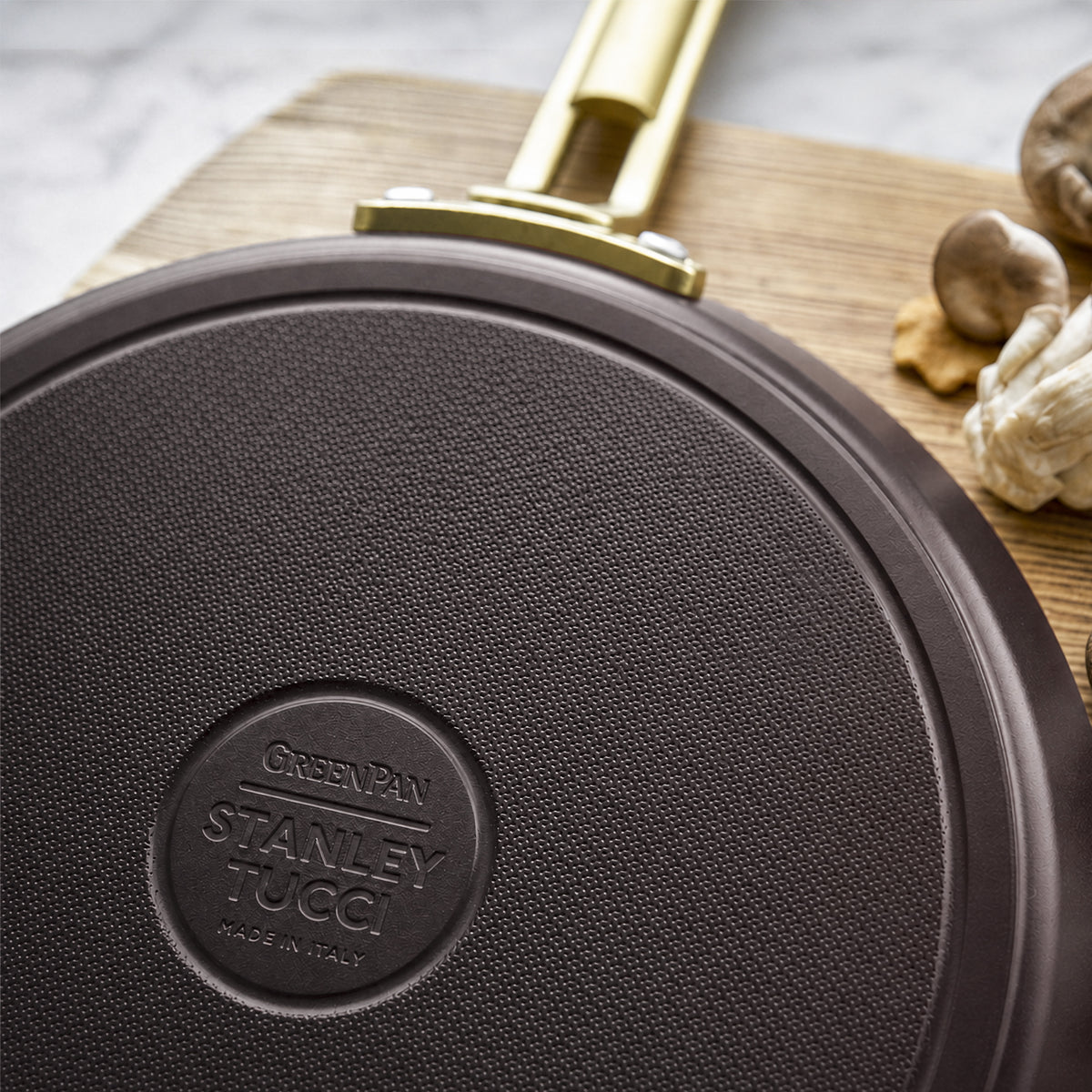Stanley Tucci 10-inch ceramic nonstick crepe and omelette pan in espresso with a gold-tone handle.