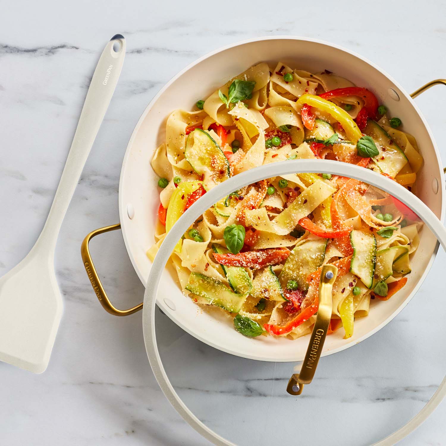 Cream ceramic nonstick everyday pan, 3.75 qt, shown with fettuccine, peas, peppers, and basil inside.