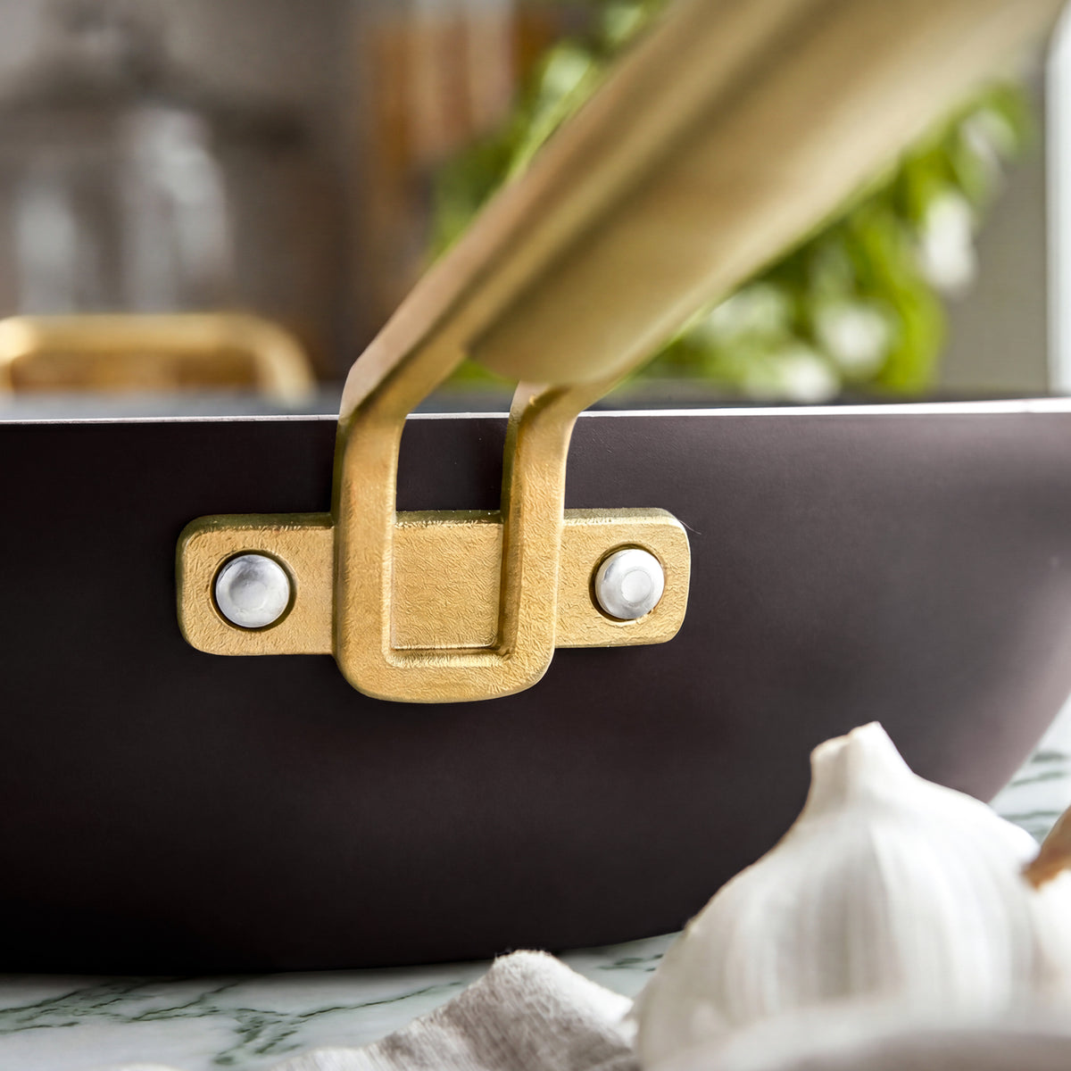 Espresso 6.5-quart Stanley Tucci ceramic nonstick Essential Pan with a gold-tone handle and rivets.