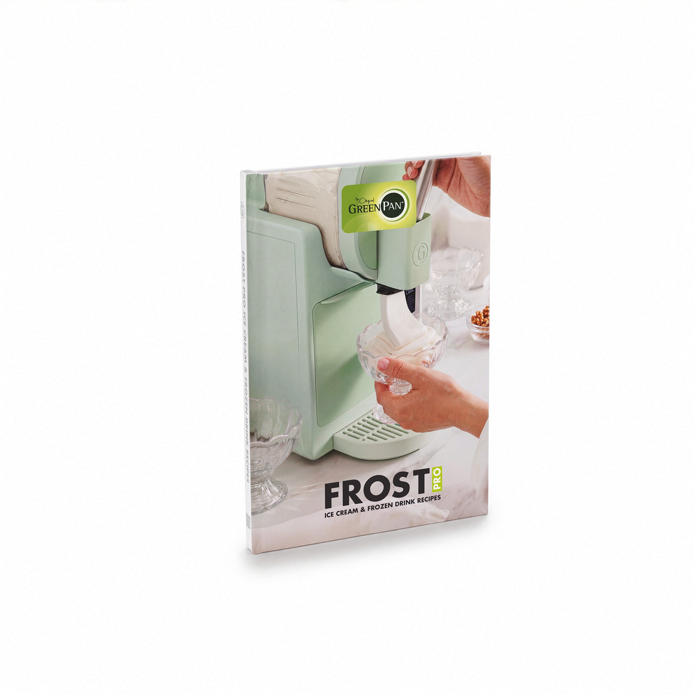 Green ice cream maker in use with a Frost Pro Ice Cream, Gelato  Frozen Drink Recipe Book visible nearby.
