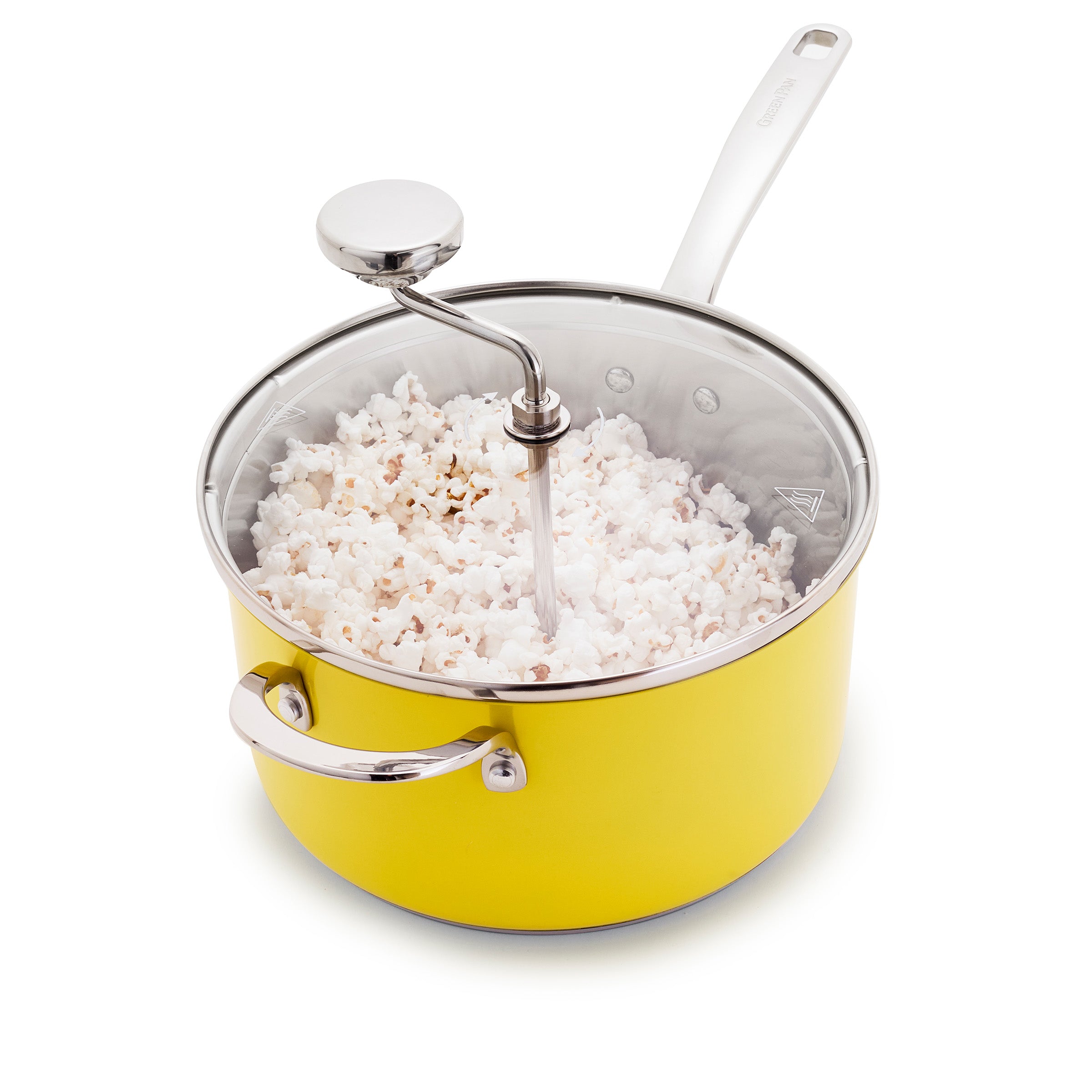Yellow stovetop popcorn maker with stainless steel body, crank handle, and filled with popcorn against a white background.