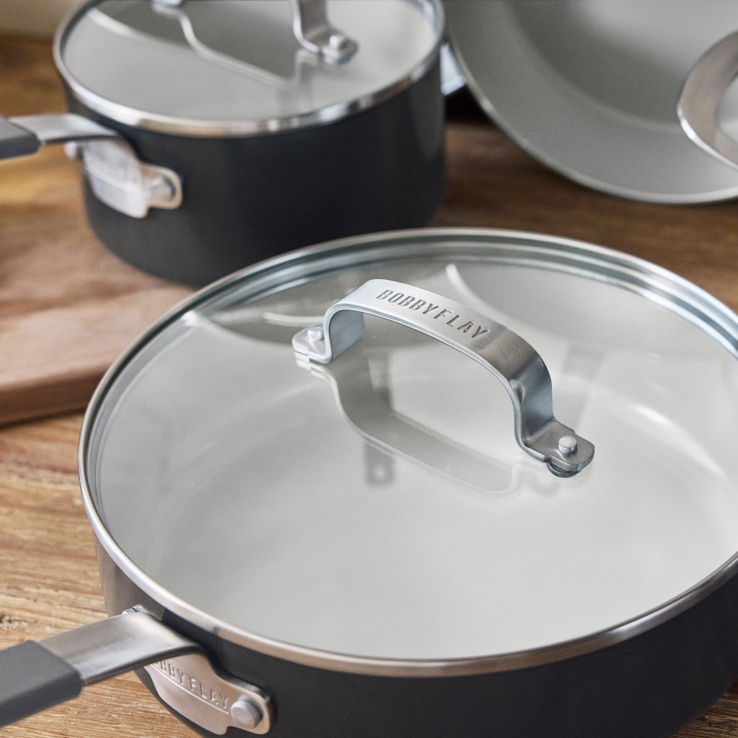 GreenPan 16-piece graphite ceramic nonstick cookware set arranged on a wooden surface.