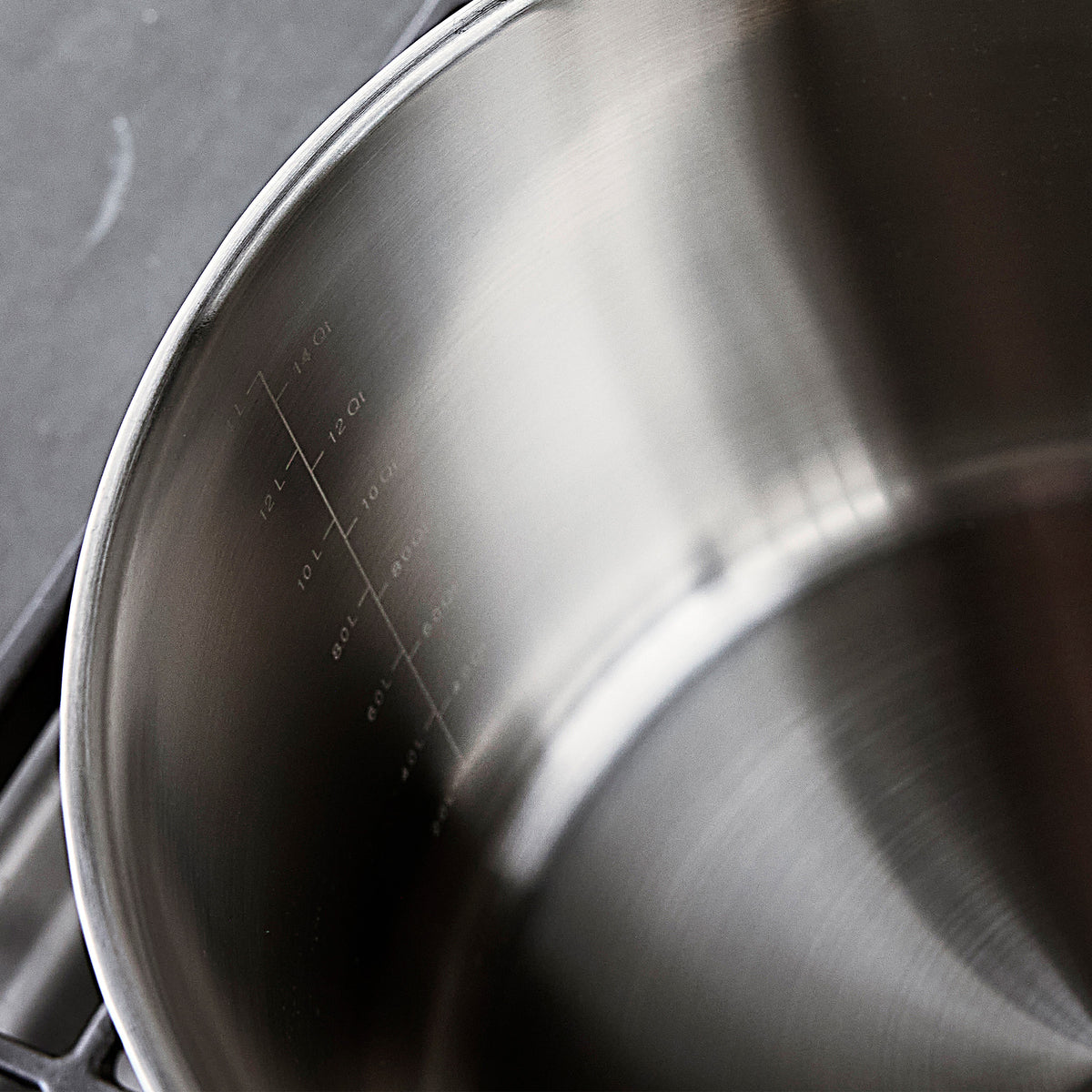 Interior of a Bobby Flay by GreenPan 16-quart stainless steel stockpot with engraved liquid measurement markings.